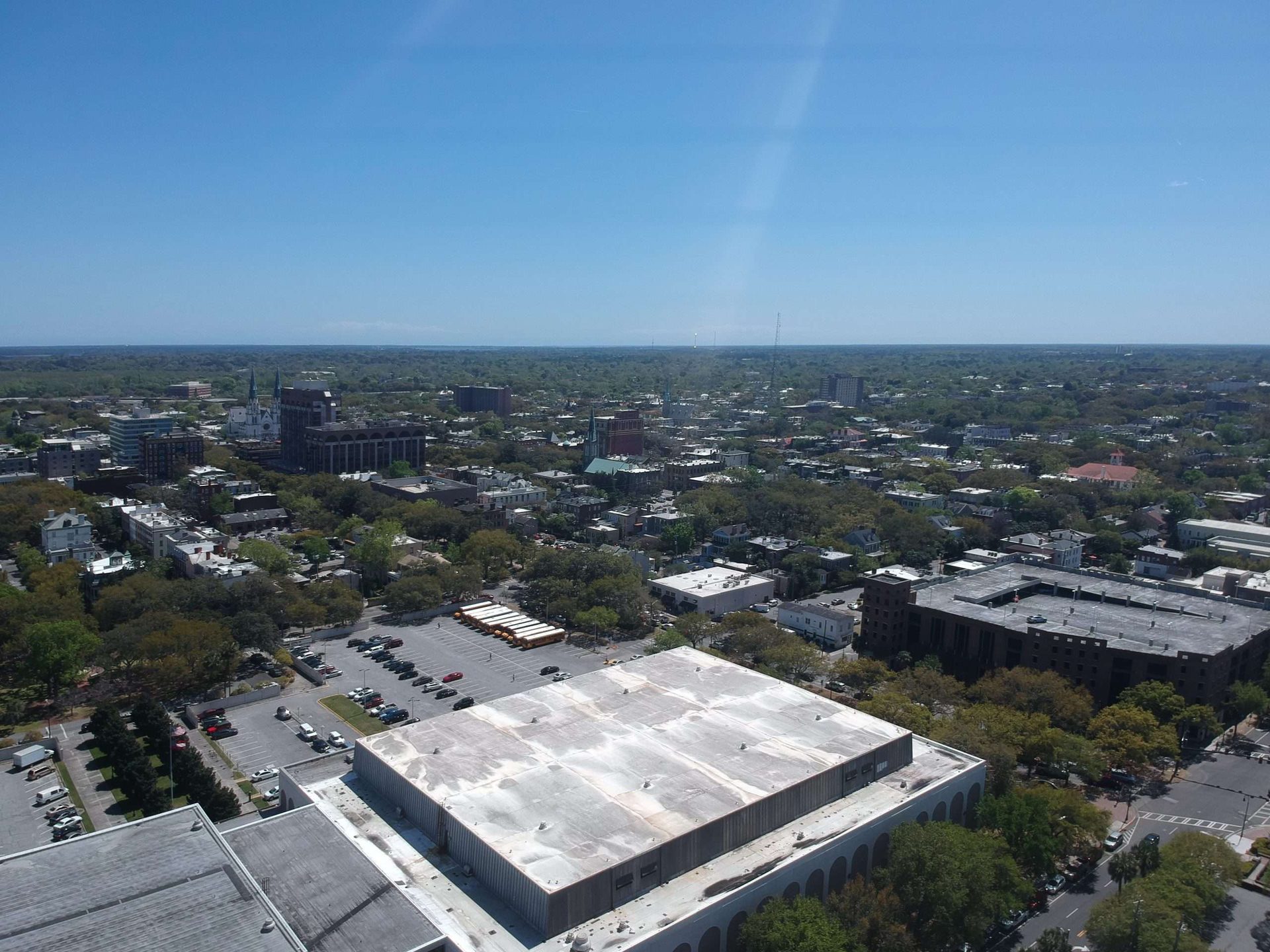 Drone view from a large flat commercial roof overlooking downtown Savannah, Georgia